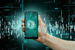 Hand holding a smartphone displaying a Bitcoin logo over a circuit board, against a digital data background.