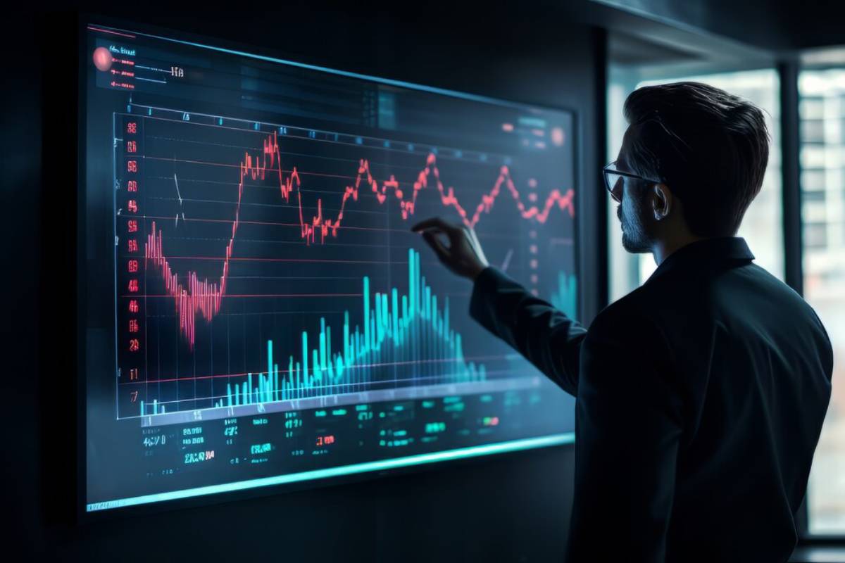 A man in a suit analyzing financial graphs on a digital screen in a dark office.