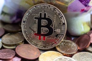 A golden Bitcoin stands out among various coins, symbolizing digital currency and investment