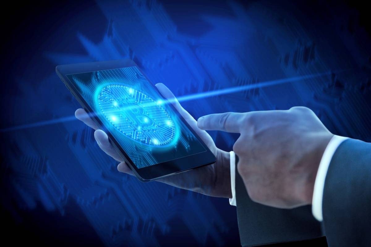 A person interacts with a glowing Bitcoin symbol on a tablet screen, representing digital currency and technology.