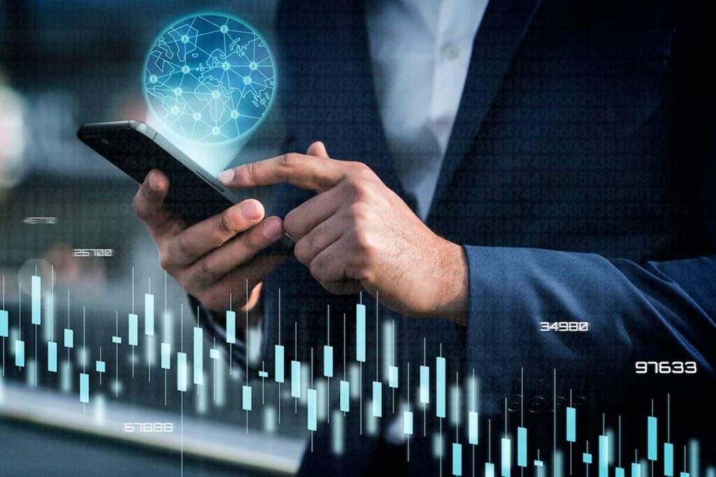 Businessman using smartphone with digital hologram of a global network and stock market data overlay.