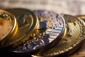Close-up of various cryptocurrency coins including Bitcoin and Litecoin, emphasizing their intricate designs and metallic textures.