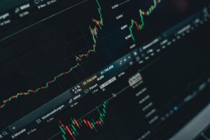 Computer screen displaying a detailed stock market graph with various indicators and data points, focused on finance and trading.