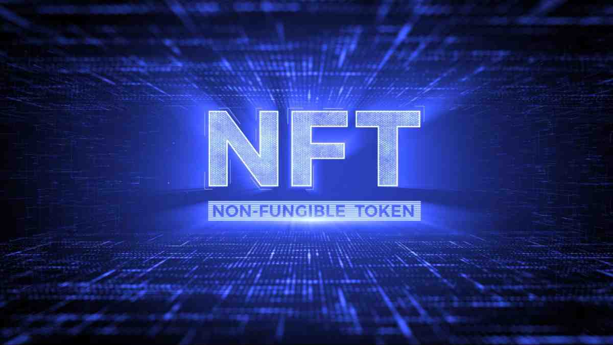 The image features the text NFT and Non-Fungible Token illuminated in blue against a digital background, symbolizing digital ownership.